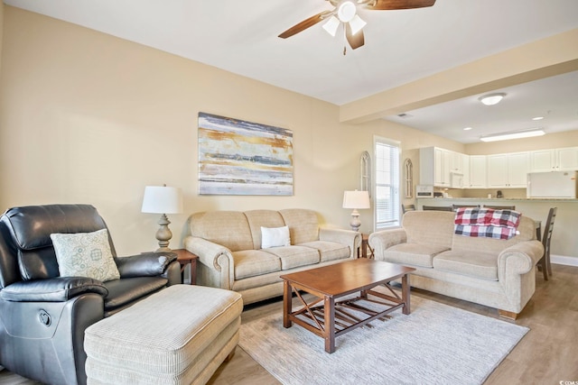 living room with ceiling fan and light hardwood / wood-style floors