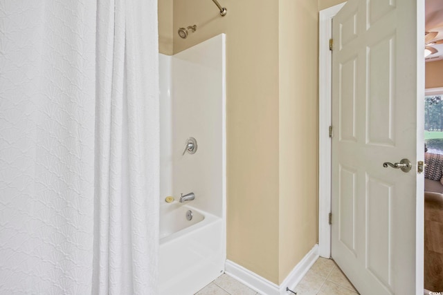 bathroom with shower / tub combo with curtain and tile patterned flooring