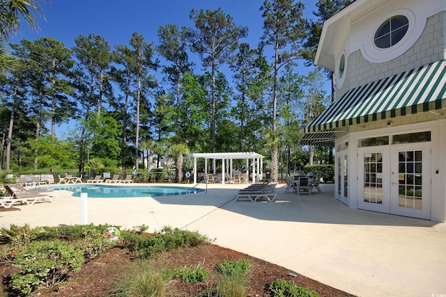 view of pool with french doors, a pergola, and a patio