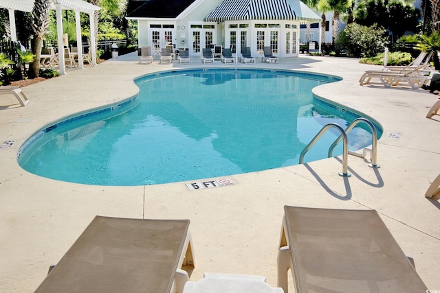 view of swimming pool with a patio