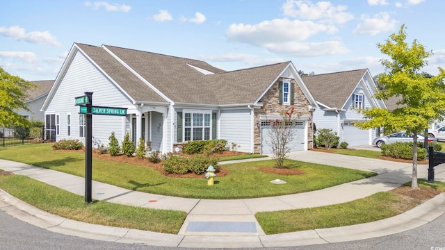 view of front of property featuring a front lawn and a garage