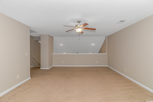 carpeted spare room with ceiling fan