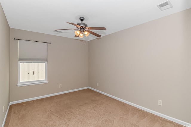 carpeted spare room featuring ceiling fan