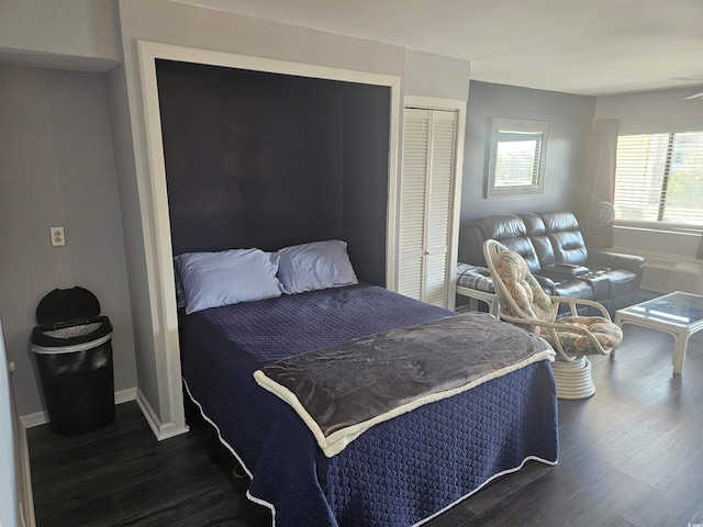 bedroom featuring dark wood-type flooring and a closet