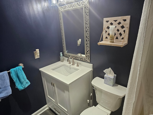 bathroom featuring vanity and toilet