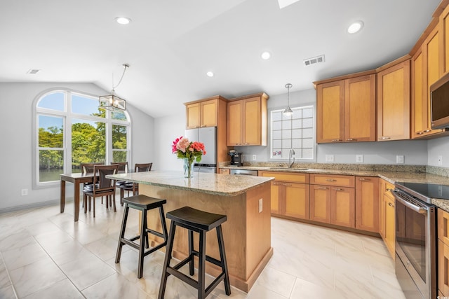 living room featuring ceiling fan with notable chandelier, light wood-type flooring, high vaulted ceiling, and sink