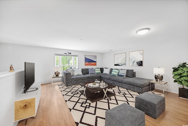 kitchen with light stone counters, pendant lighting, appliances with stainless steel finishes, and a center island