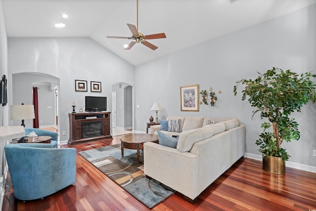 living room featuring ceiling fan, high vaulted ceiling, and dark hardwood / wood-style flooring