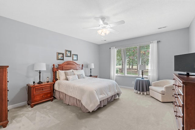 bedroom with ceiling fan and light carpet