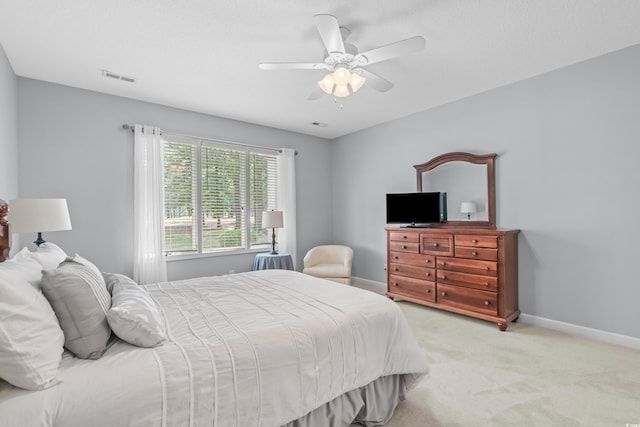 bedroom featuring light carpet and ceiling fan