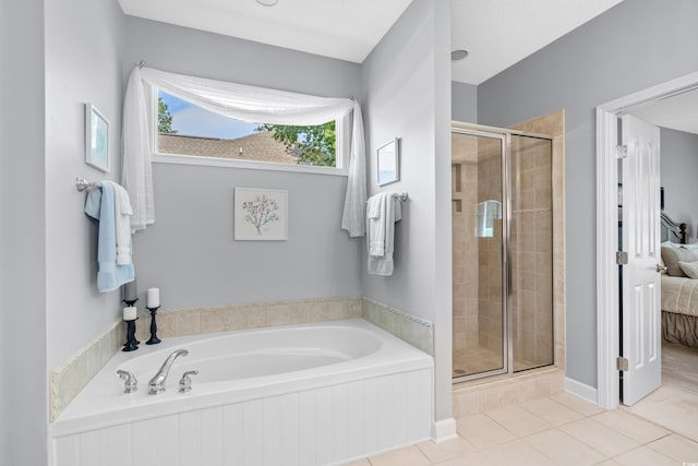 bathroom with shower with separate bathtub and tile patterned floors