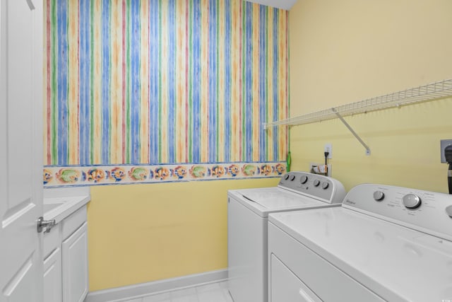 laundry room featuring cabinets and washing machine and dryer