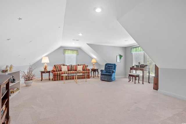 sitting room featuring light carpet, lofted ceiling, and a wealth of natural light