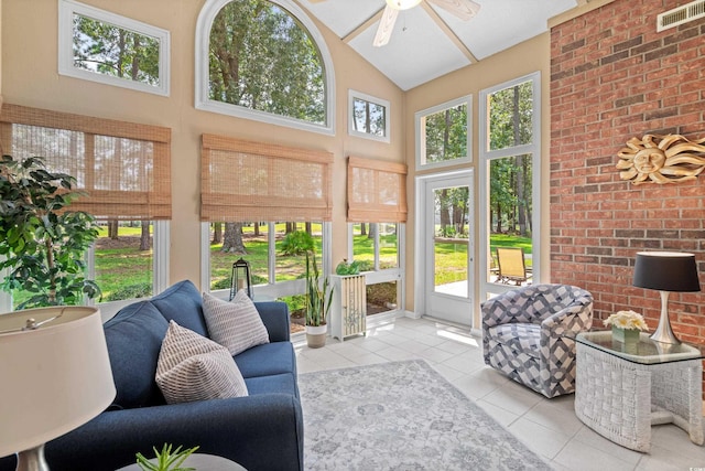 sunroom featuring lofted ceiling, a wealth of natural light, and ceiling fan