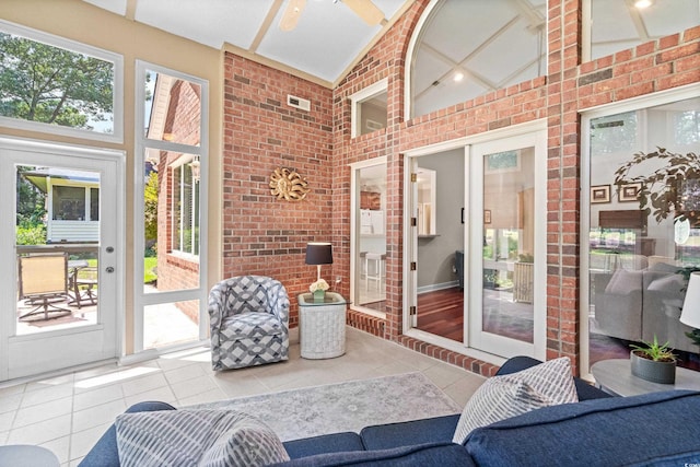 sunroom with lofted ceiling, a wealth of natural light, and ceiling fan