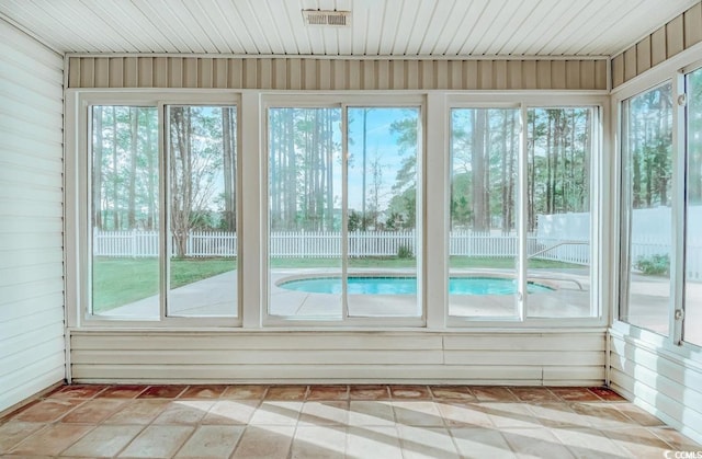 unfurnished sunroom featuring visible vents