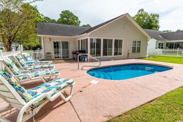 view of pool featuring a yard and a patio