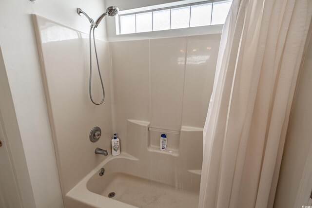 bathroom featuring shower / bath combo with shower curtain