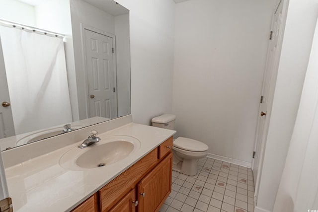 full bathroom featuring tile patterned floors, baseboards, toilet, and vanity