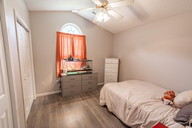 bedroom featuring vaulted ceiling, a closet, ceiling fan, and hardwood / wood-style flooring