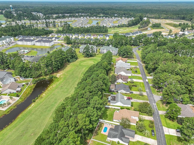 drone / aerial view with a residential view, a water view, and golf course view