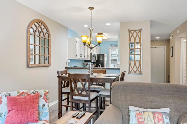 dining room with an inviting chandelier and dark hardwood / wood-style flooring