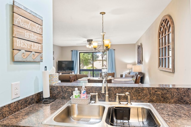 kitchen featuring decorative light fixtures, sink, and a notable chandelier