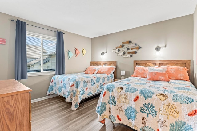 bedroom with wood finished floors and baseboards