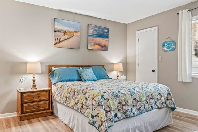 bedroom featuring light wood-type flooring and baseboards