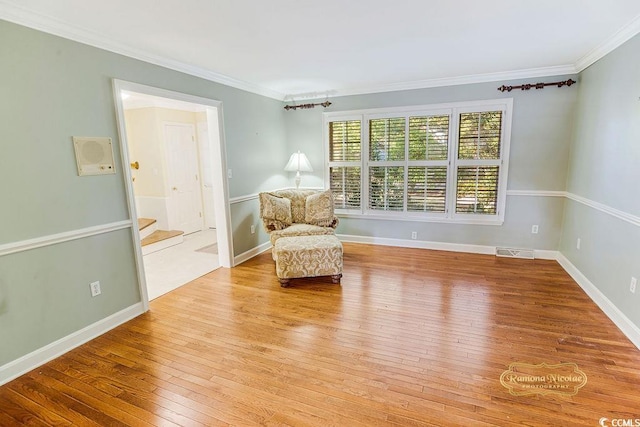 unfurnished room featuring light hardwood / wood-style flooring and ornamental molding