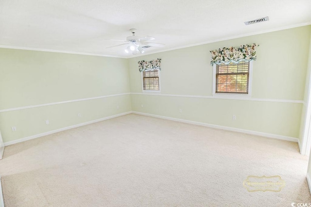 spare room featuring light carpet, ceiling fan, and ornamental molding