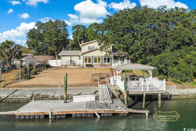 dock area featuring a deck with water view