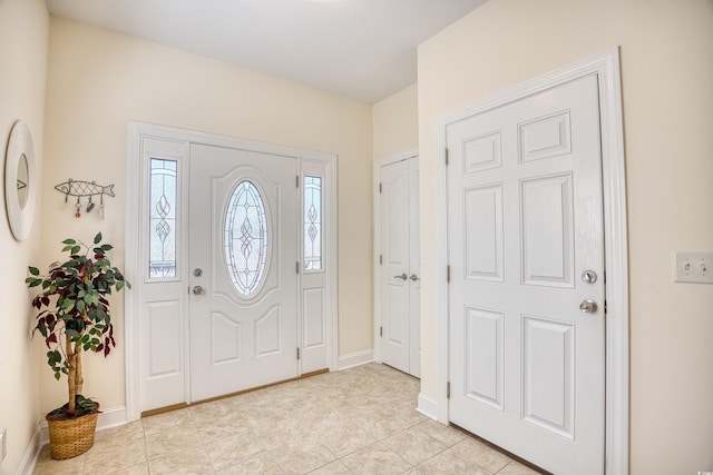 foyer entrance with light tile patterned floors