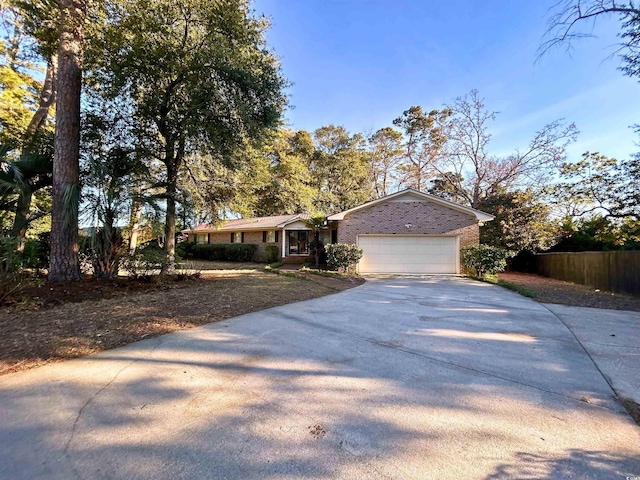 902 N 11th Ave N, North Myrtle Beach, SC 29582 - ranch-style home featuring brick siding, an attached garage, fence, and driveway