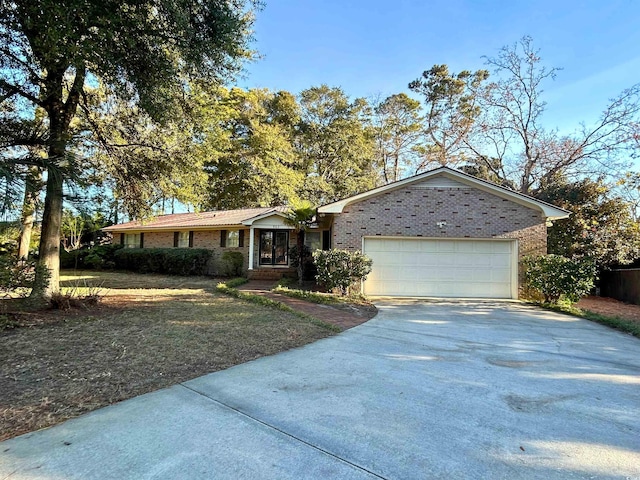 902 N 11th Ave N, North Myrtle Beach, SC 29582 - ranch-style home featuring brick siding, an attached garage, and driveway