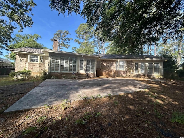 902 N 11th Ave N, North Myrtle Beach, SC 29582 - view of front of home featuring brick siding, a chimney, a patio, and entry steps
