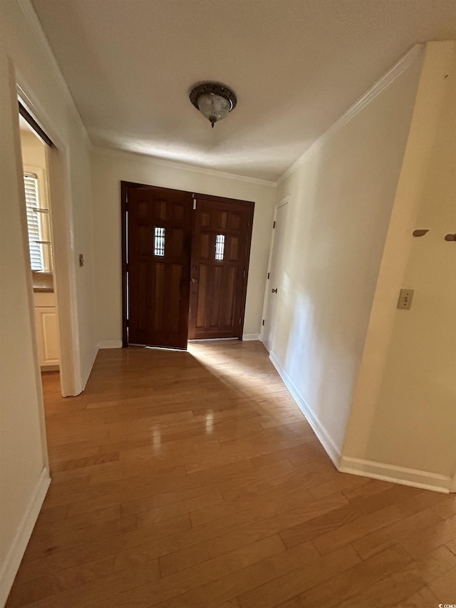 foyer entrance with hardwood / wood-style flooring and ornamental molding