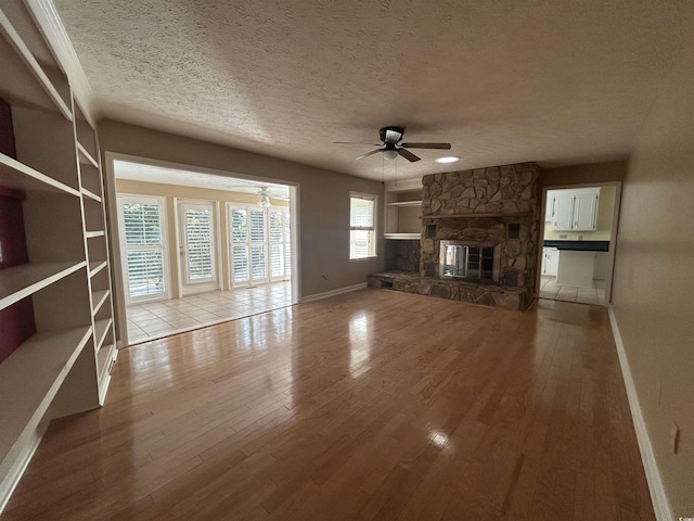 902 N 11th Ave N, North Myrtle Beach, SC 29582 - unfurnished living room with a textured ceiling, ceiling fan, and wood finished floors
