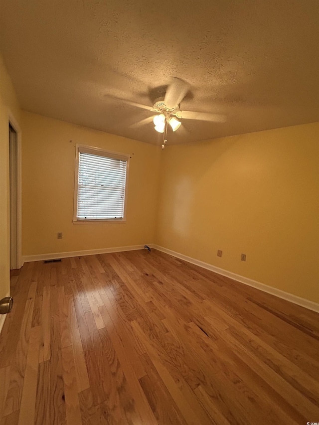 902 N 11th Ave N, North Myrtle Beach, SC 29582 - empty room with baseboards, ceiling fan, a textured ceiling, and wood finished floors