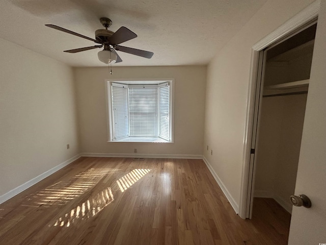 902 N 11th Ave N, North Myrtle Beach, SC 29582 - unfurnished bedroom with baseboards, ceiling fan, a closet, and wood finished floors
