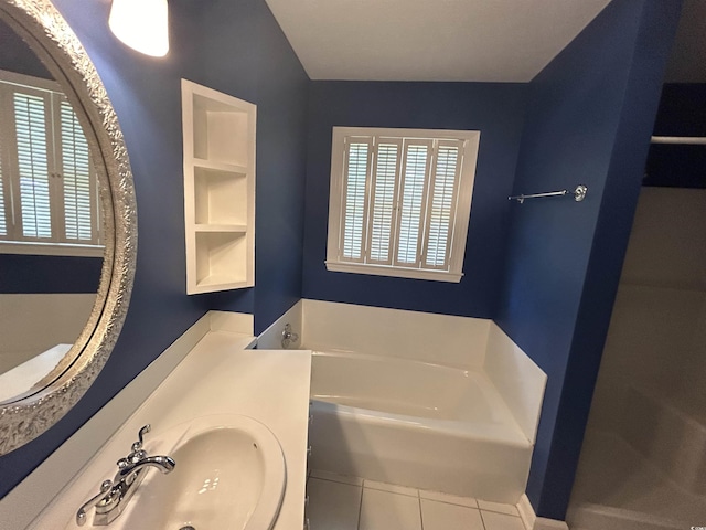 bathroom featuring a healthy amount of sunlight, sink, a bath, and tile patterned floors