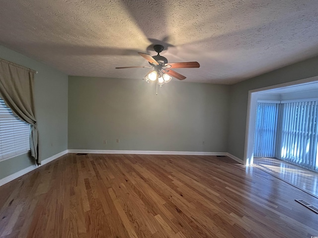 902 N 11th Ave N, North Myrtle Beach, SC 29582 - unfurnished room with a textured ceiling, ceiling fan, and wood finished floors