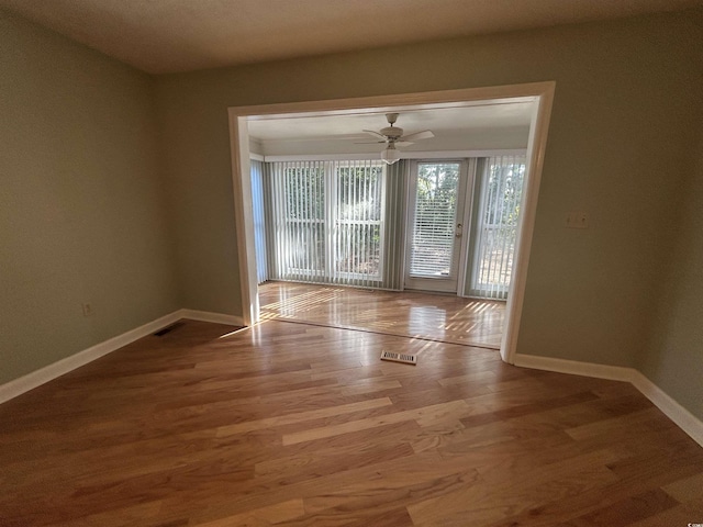 902 N 11th Ave N, North Myrtle Beach, SC 29582 - empty room with baseboards, a ceiling fan, wood finished floors, and visible vents