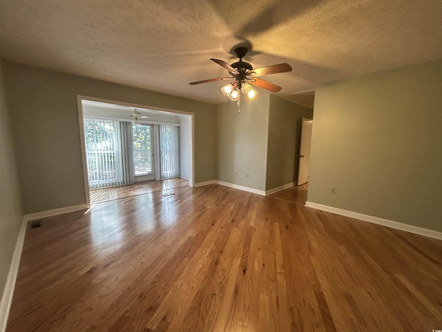 902 N 11th Ave N, North Myrtle Beach, SC 29582 - unfurnished room featuring baseboards, a textured ceiling, ceiling fan, and wood finished floors