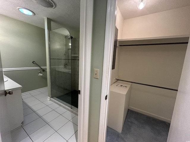 902 N 11th Ave N, North Myrtle Beach, SC 29582 - bathroom with tile patterned flooring, a textured ceiling, a stall shower, and vanity