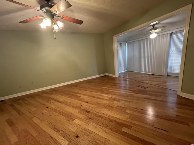 empty room featuring wood-type flooring and a textured ceiling