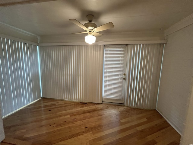 unfurnished room with ceiling fan and wood-type flooring