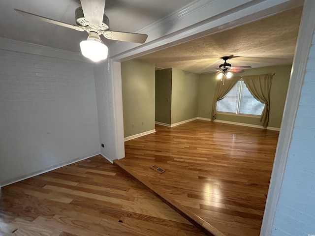 spare room with ceiling fan and wood-type flooring