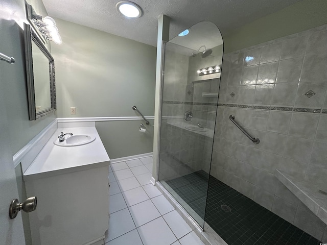 902 N 11th Ave N, North Myrtle Beach, SC 29582 - bathroom with vanity, a textured ceiling, walk in shower, and tile patterned floors