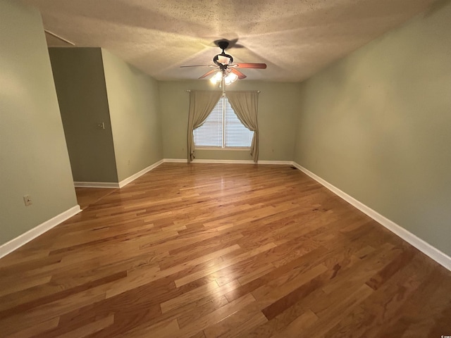 spare room featuring hardwood / wood-style floors, a textured ceiling, and ceiling fan